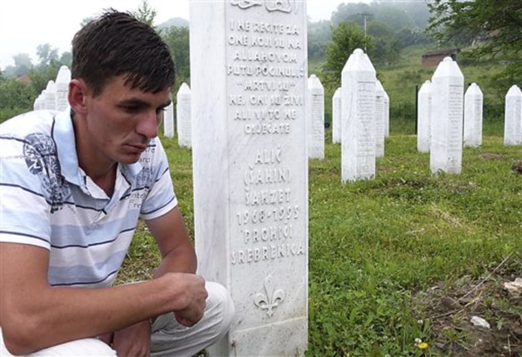Izudin Alic visits the grave of his father at the memorial in Potocari, near Srebrenica, on Tuesday, May 31,2011.